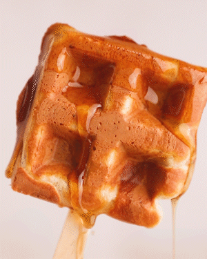 Dipping a Buttermilk Waffle Pop Into Syrup